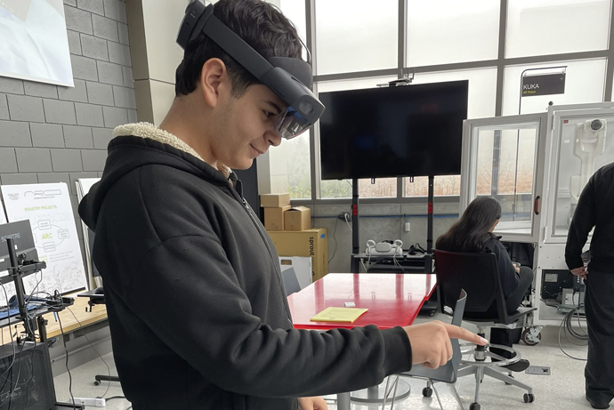 Photo of a male student with AI goggles on