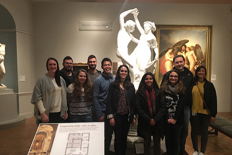 group of students standing in front of a white sculpture and a painting on the wall at the Detroit Institute of Art