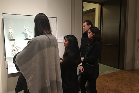 students observing white sculptures in a glass case at the Detroit Institute of Art