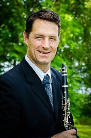 Man in suit holding clarinet