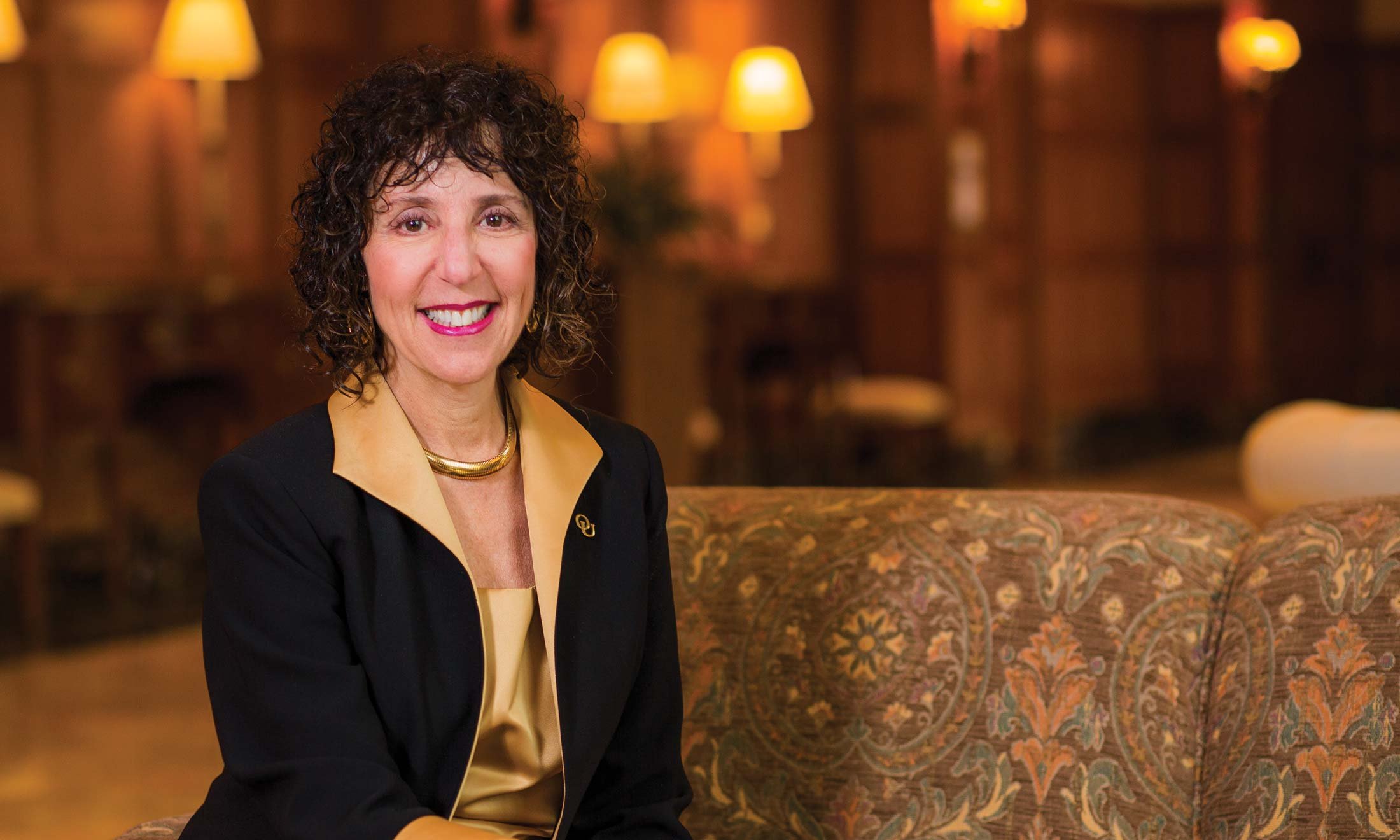 Dr. Ora Hirsch Pescovitz, Oakland University's seventh president sitting on a couch
