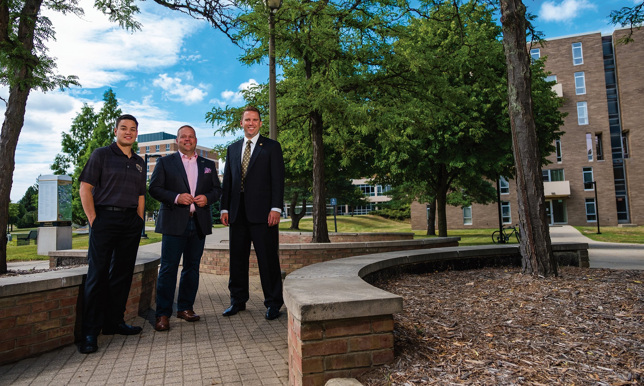 Mayor Rob Ray of Auburn Hills, Mayor Bryan Barnett of Rochester Hills  and Mayor Kevin McDaniel of Rochester stand together on OU's campus.