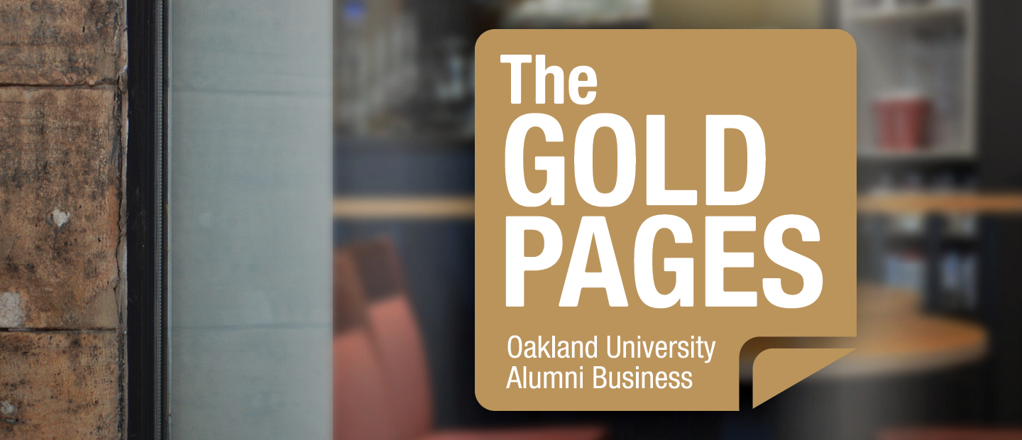 Gold Pages A gold square with text that reads "The Gold Pages. Oakland University Alumni Business" on a window