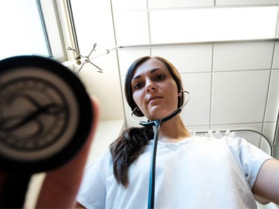 Upward angle shot of a Woman with stethescope on.