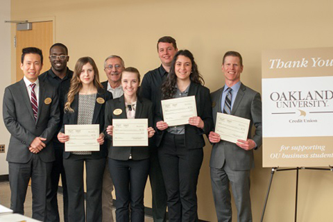 Business Scholars team L I F O the Party with judges from the final case competition, holding awards 