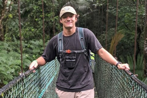 Business economics student, Dakota Zehler, on a bridge in the rainforest.