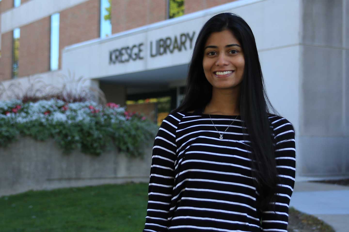 Naveena in front of the library