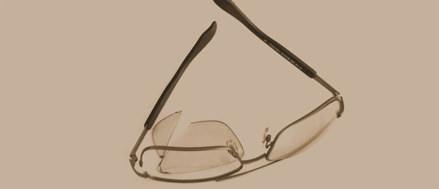 A pair of glasses with a broken lense