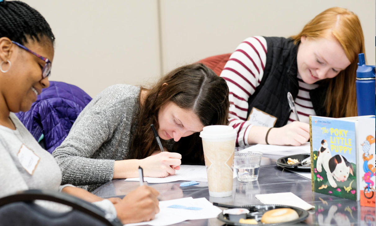 People writing at the table