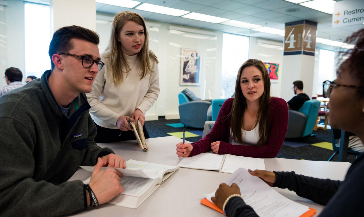 Group of students working together with open books