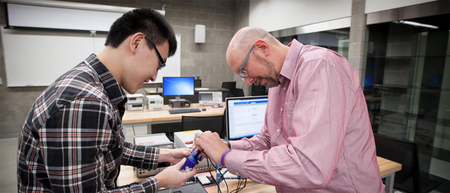 professor helping engineering student