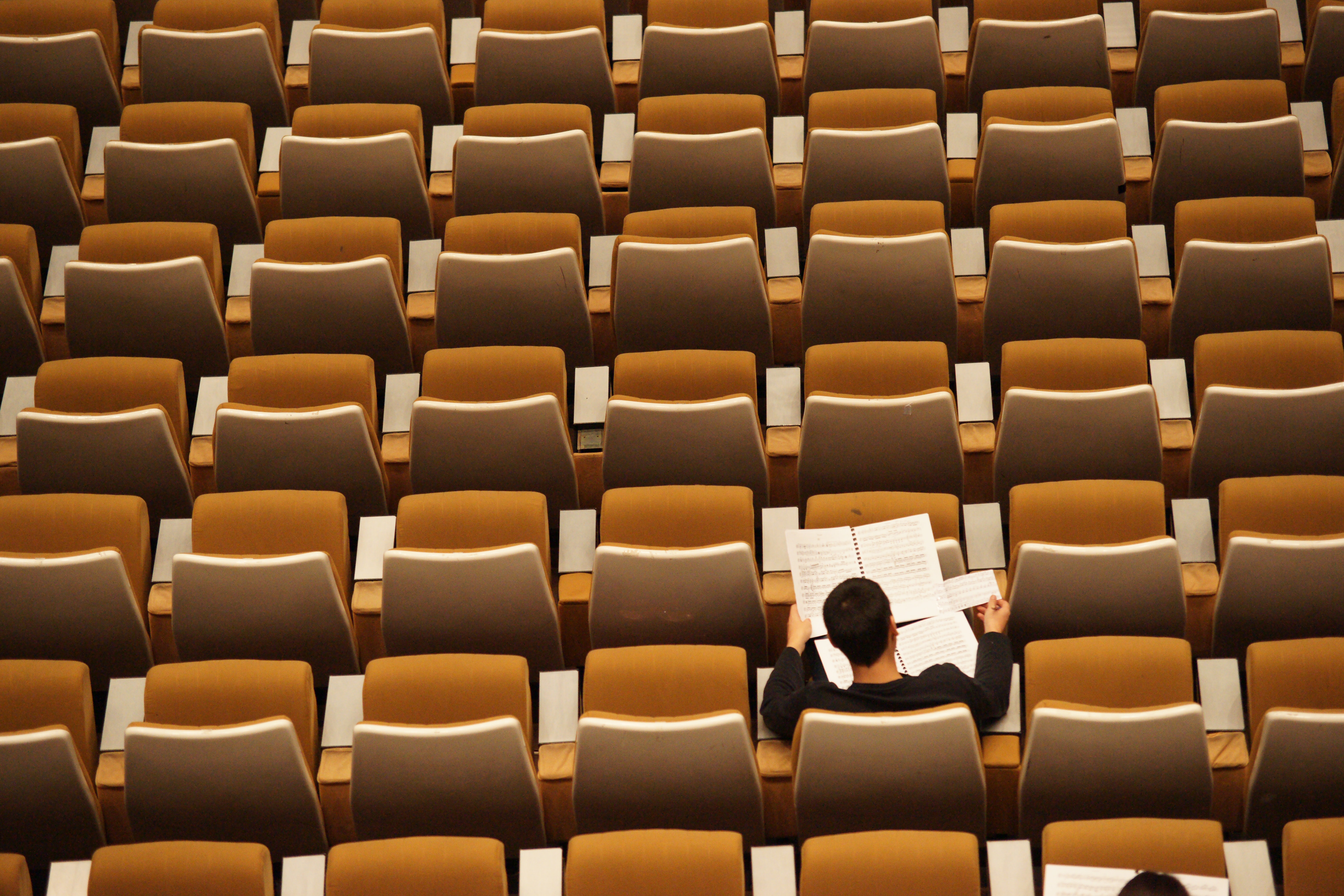 Student alone in a large class.