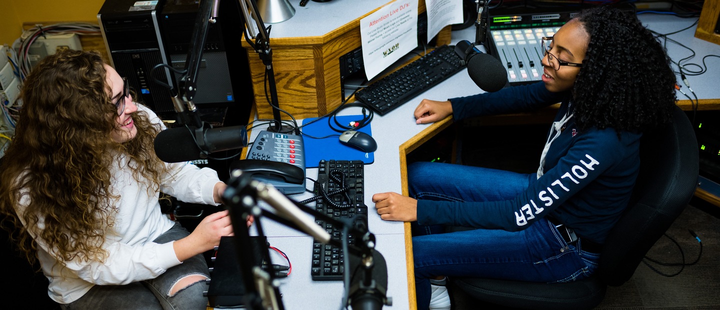 Two students talking on air in the WXOU radio station