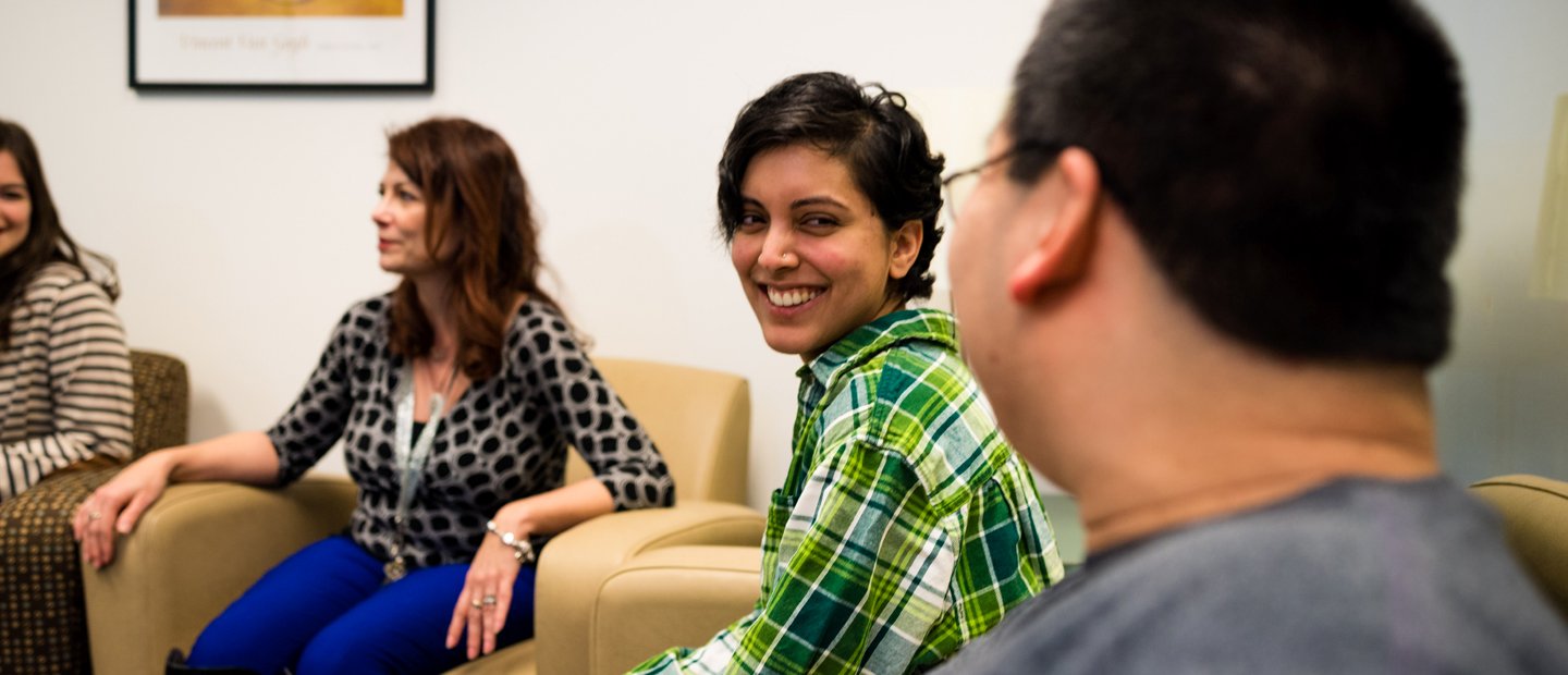 Counseling Organizations Four people seated in a row of arm chairs, smiling.