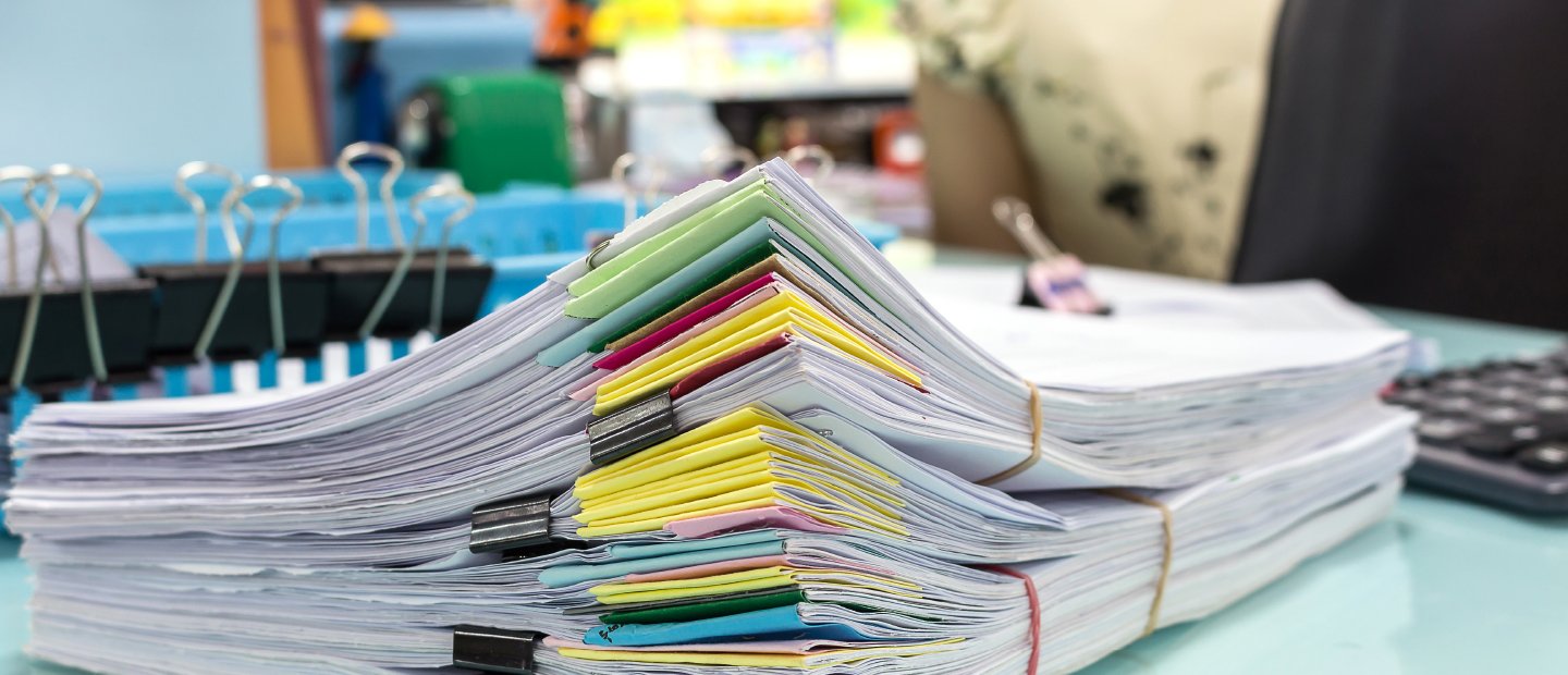 Piles of paper with colorful page markers