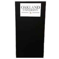 A black carpet podium with a white Oakland University sign on the front.