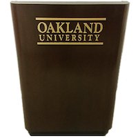 A wooden podium with Oakland University in gold lettering on the front.