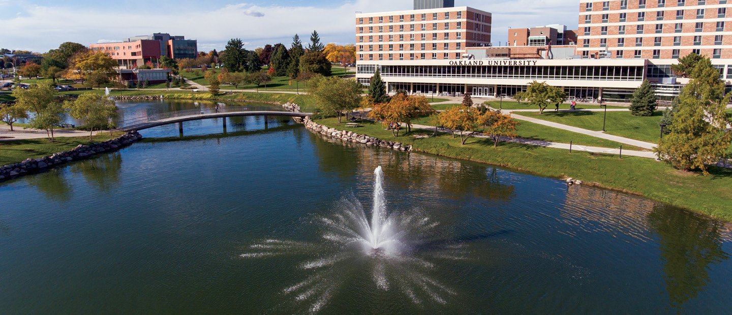 aerial photo of Oakland University with bear lake in front and buildings in the background