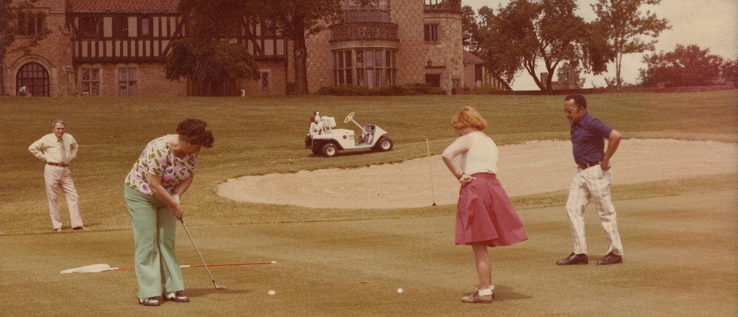 A historic photo of people putting on a golf course