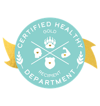 A digital badge that says Certified Healthy Department Gold Recipient with a gold ribbon and symbols