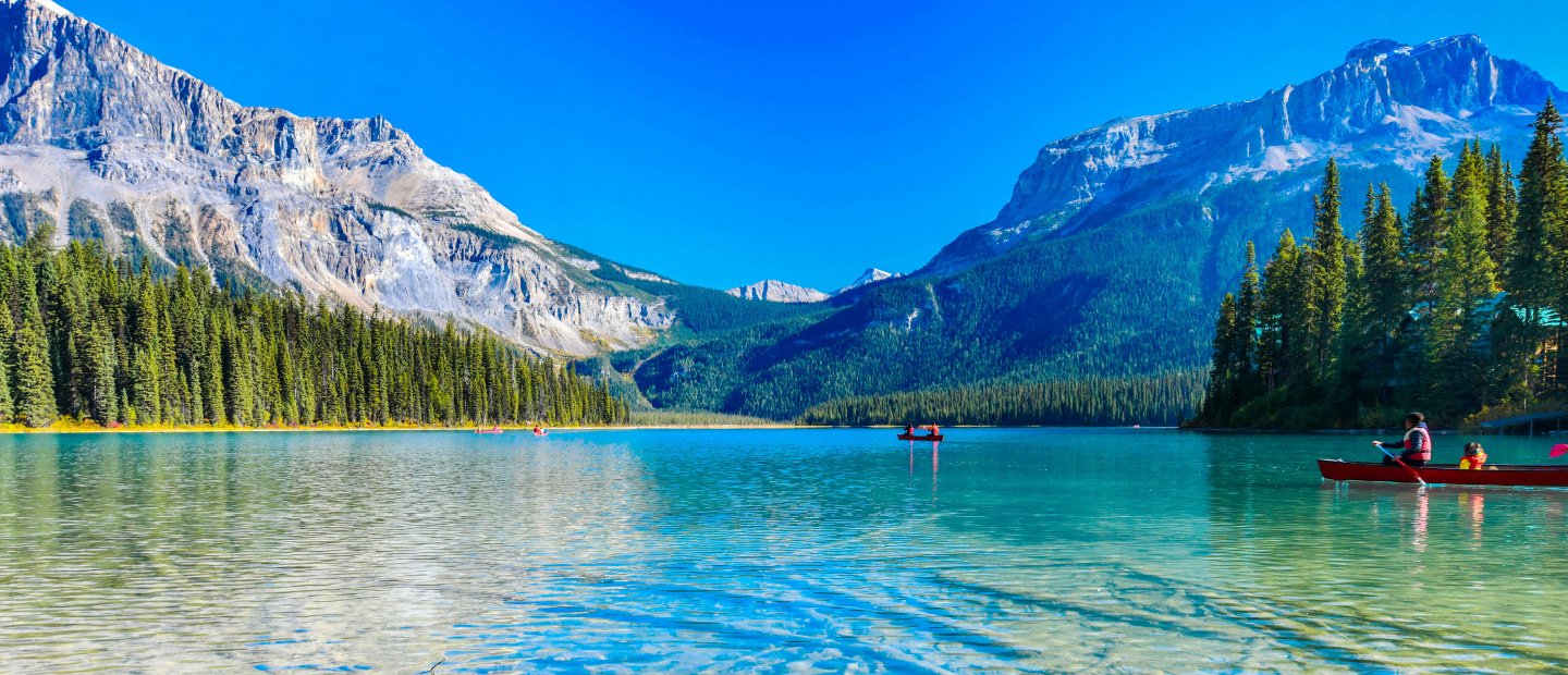 Kayakers on a lake in the mountains in Canada.