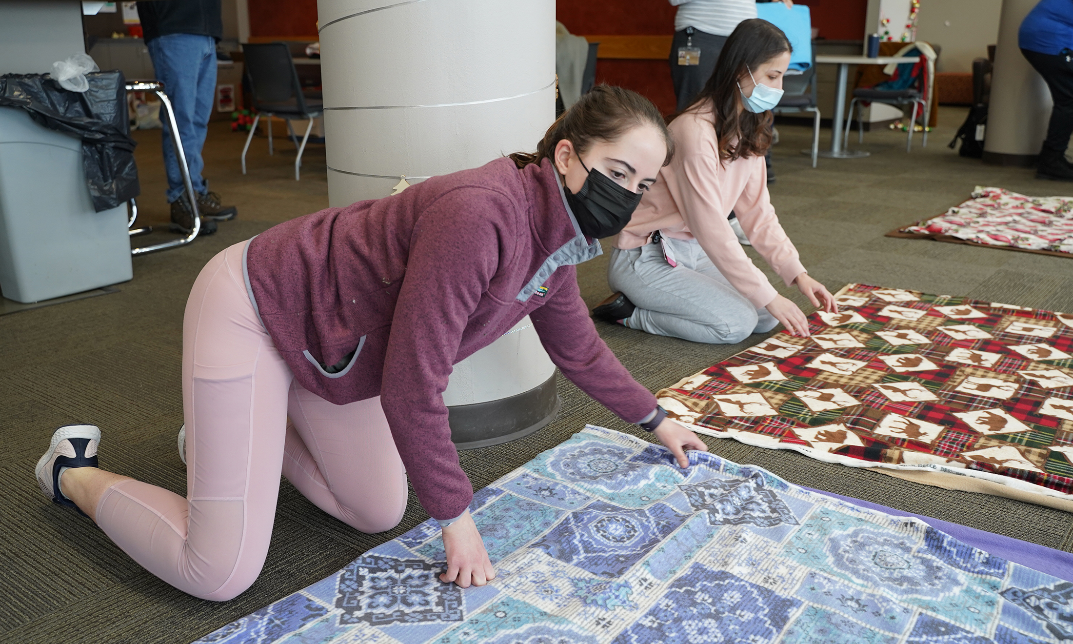 An image of a student making a tie blanket.