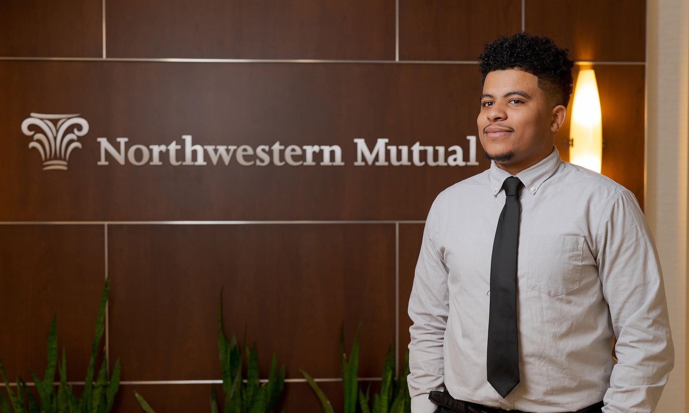 A man standing in front of a Northwestern Mutual sign. 
