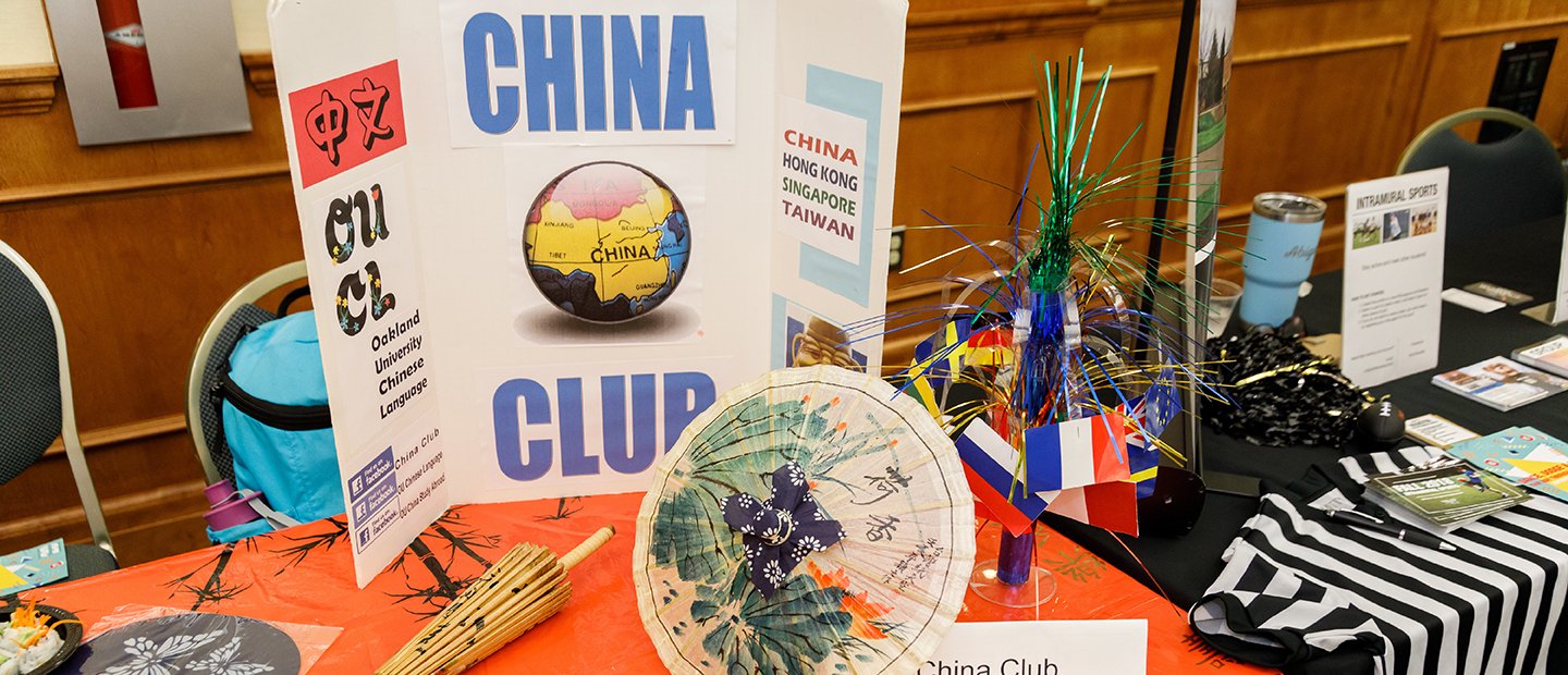 A table with Chinese accessories and a sign that says "China Club".