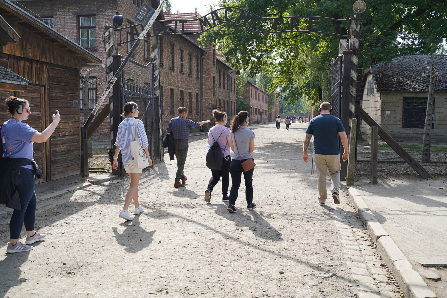 A group of OUWB students and faculty walk through the entrance gate to Auschwitz 1