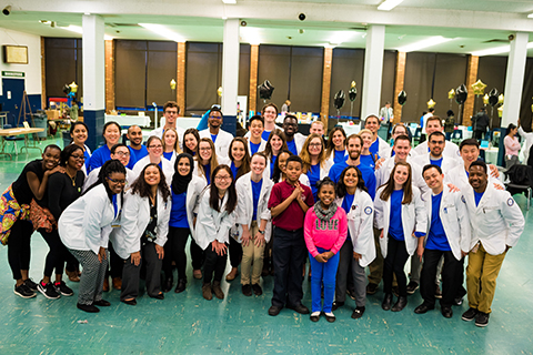 Group photo of O U W B medical student volunteers in white lab coats