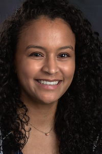 woman with dark hair smiling at the camera