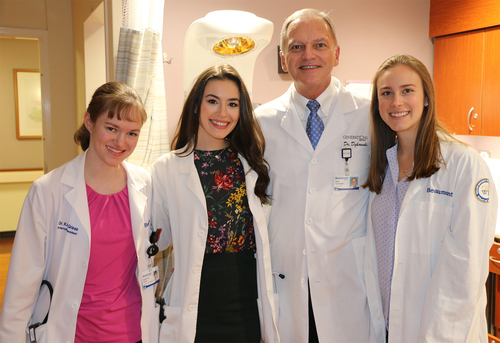 Mark Dykowski, M.D., with three of the OUWB students he delivered.
