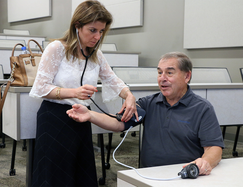 OUWB Standardized Patient demonstrates blood pressure.