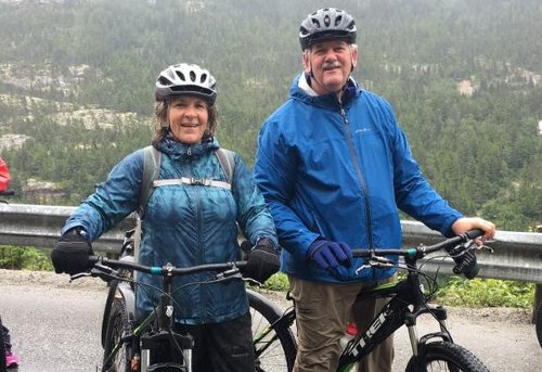 An image of Steve Collard and wife, Lydia, biking in Alaska.
