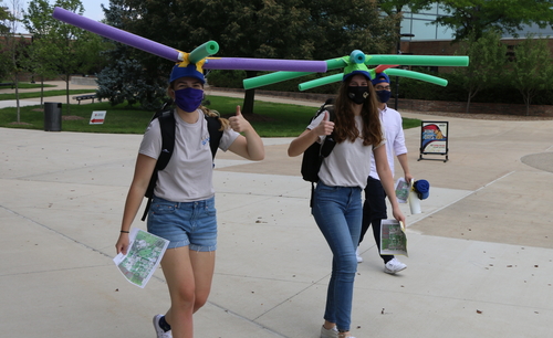 An image of two students from OUWB's Class of 2024 wearing noodle hats