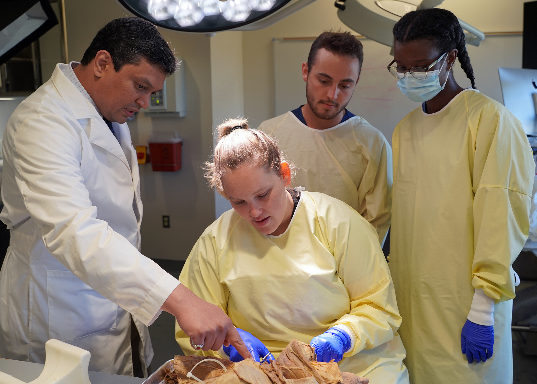 A group of students and faculty in an anatomy lab