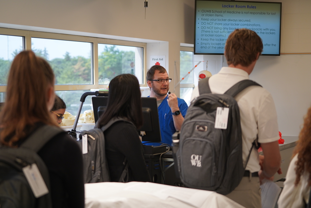An image of Dan Schlegel talking to students