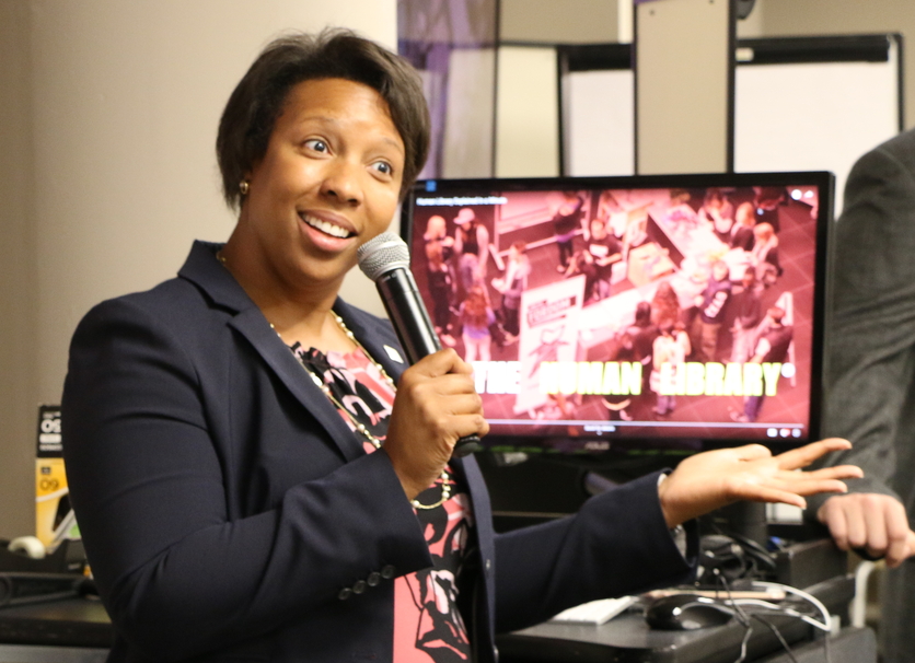 An image of Caryn Reed-Hendon talking to a group