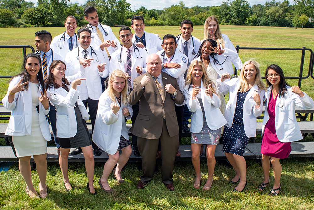 An image of Dr. Mezwa and students at the 2019 OUWB White Coat Ceremony