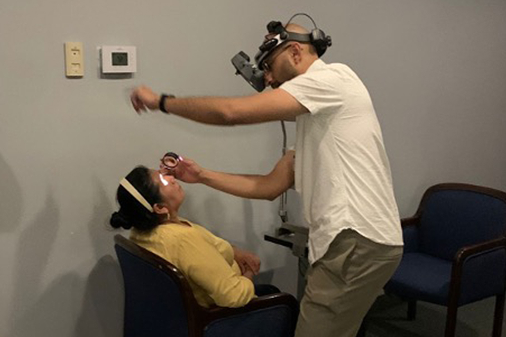 An image of a student examining a patient
