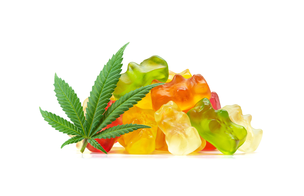 An image of a marijuana leaf and marijuana edibles