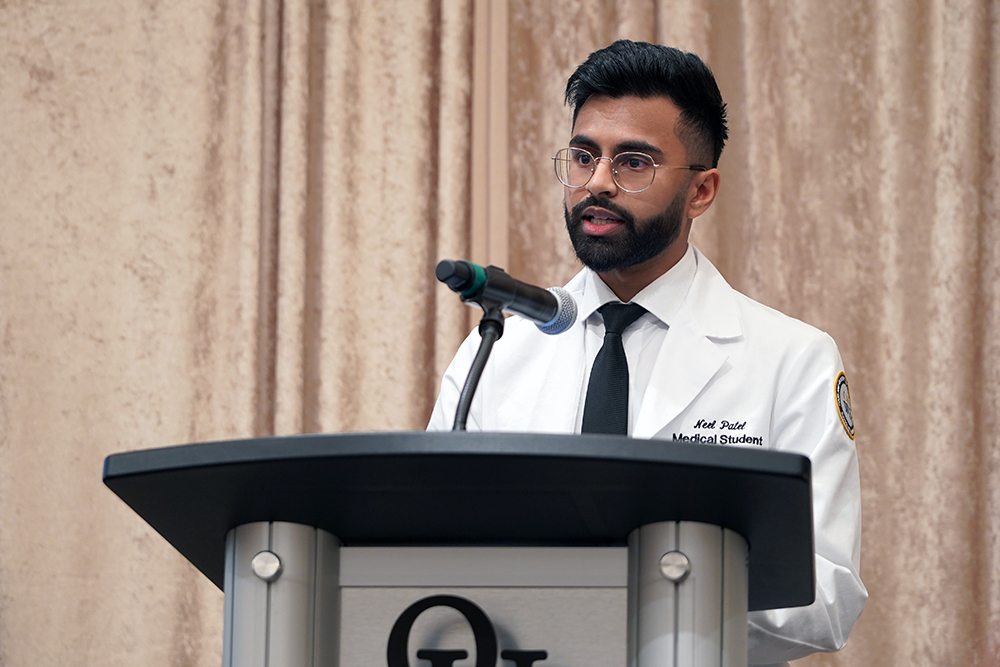 An image of Neel Patel at a podium
