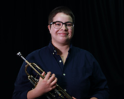 A photo of Amanda Ross holding a trumpet.