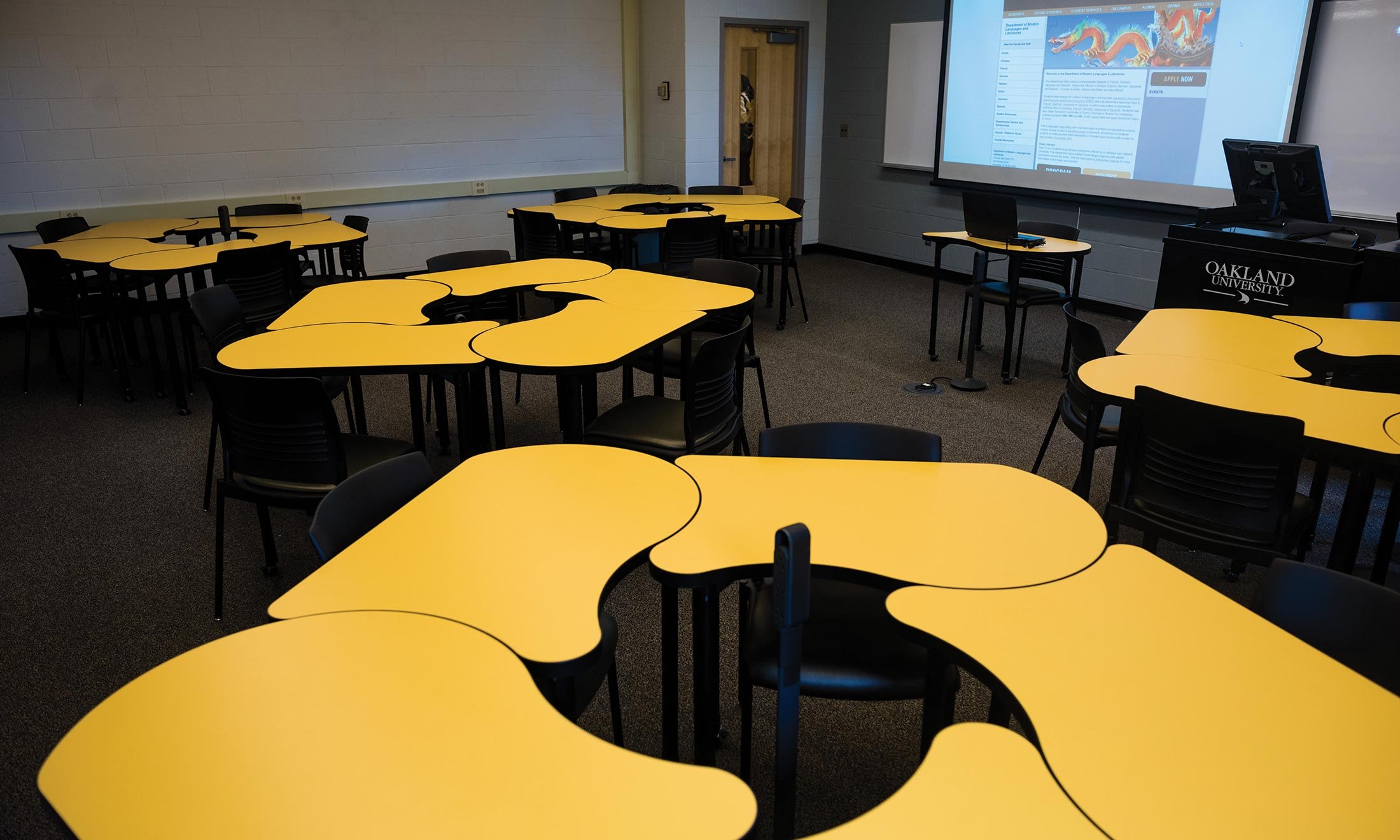 Department of Modern languages and Literatures classroom full of yellow desks with plugs for power