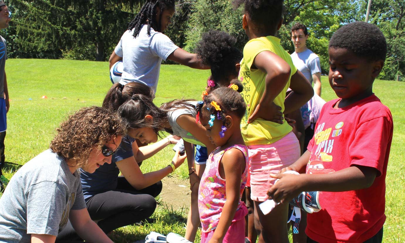 The Healthy Pontiac, We Can! Initiative staff handing out drinks to children after a soccer game in Pontiac, Michigan