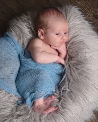 Photo of baby wrapped in blue blanket
