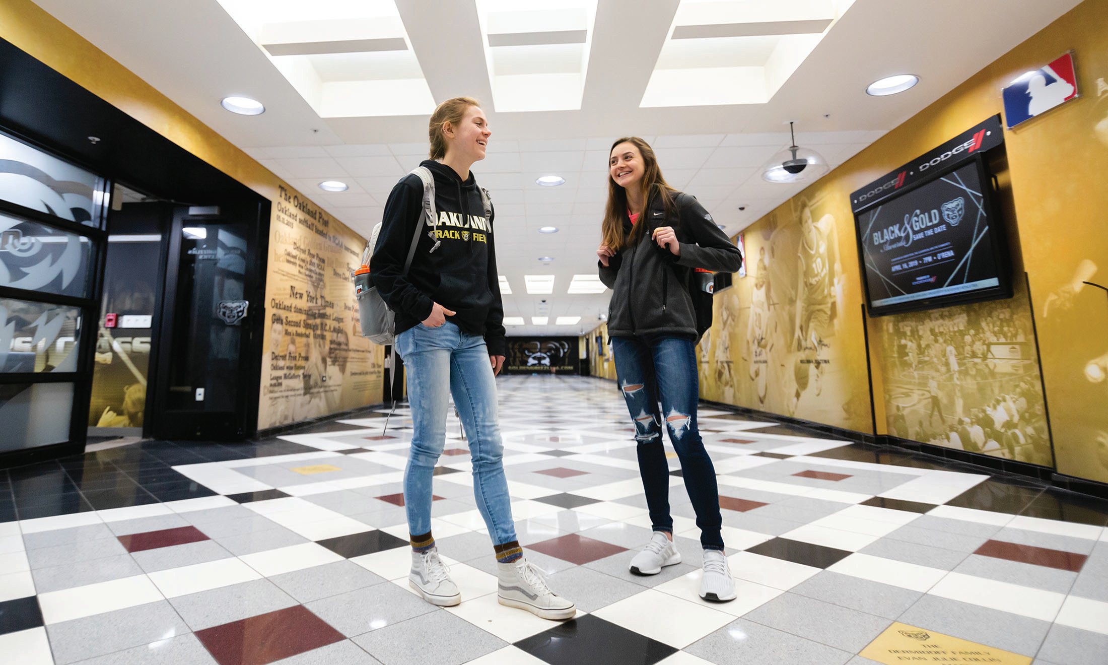 Two female students standing in Oakland University O’Rena hallway