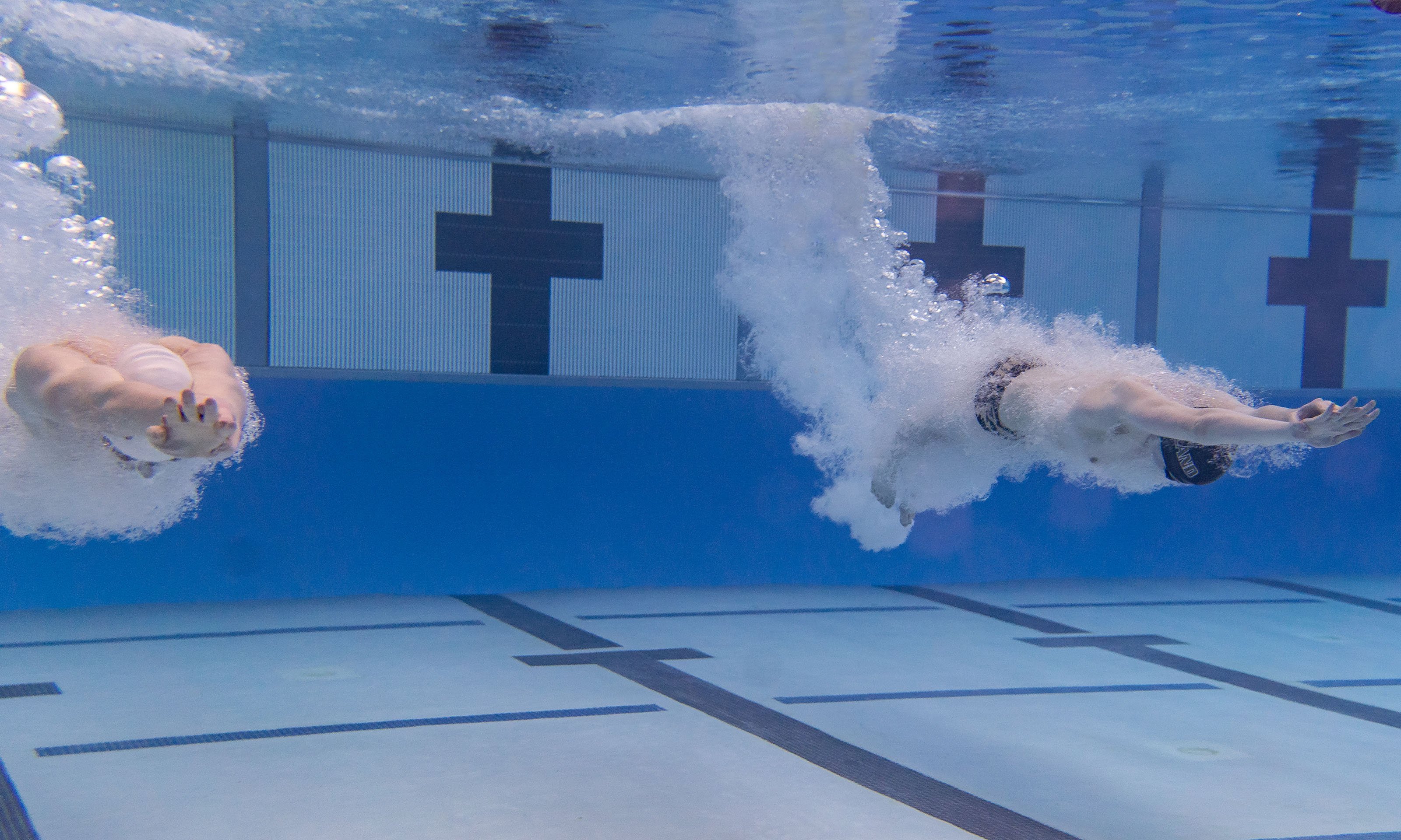 two male swimmers underwater