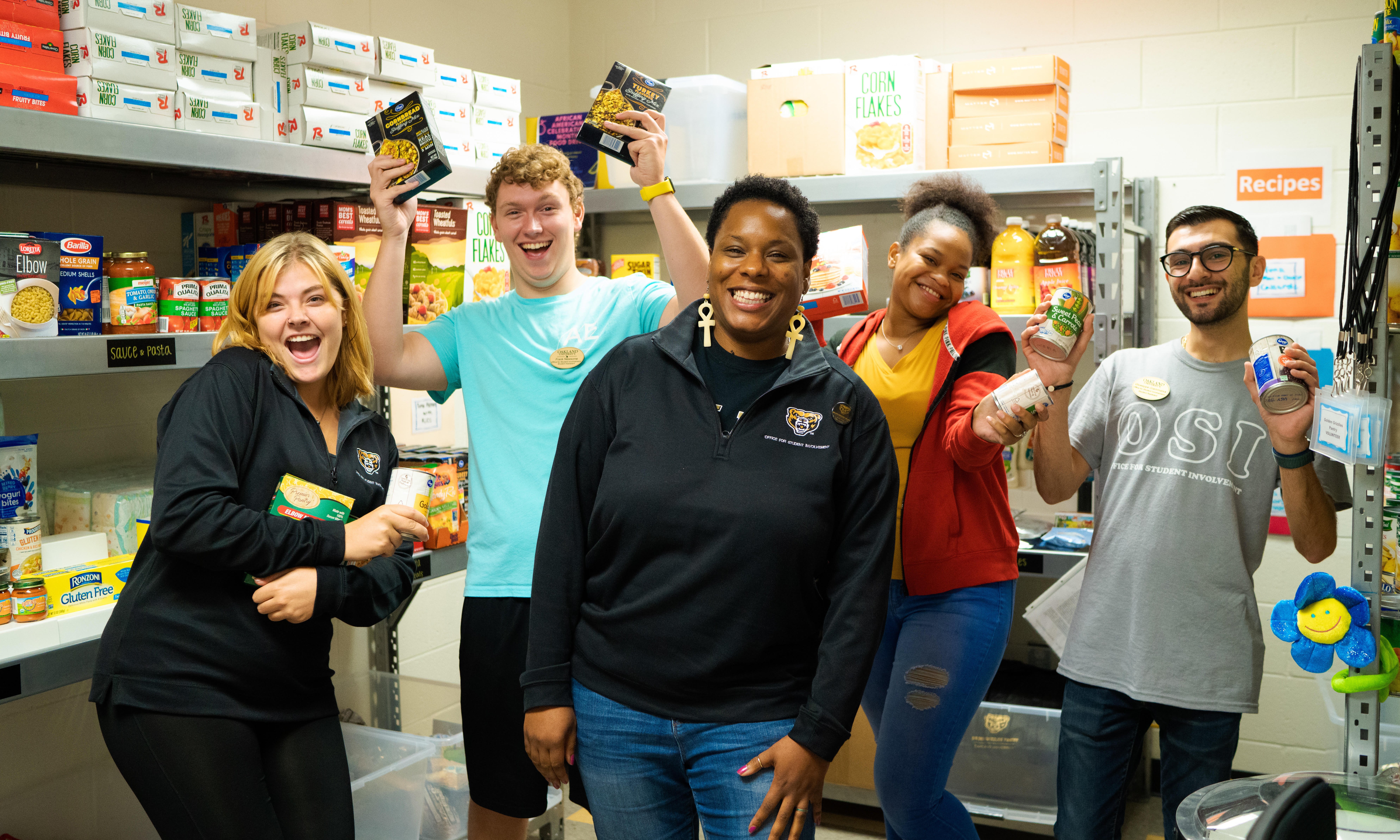 Raenece D. Johnson and students pose for a photo in a food pantry