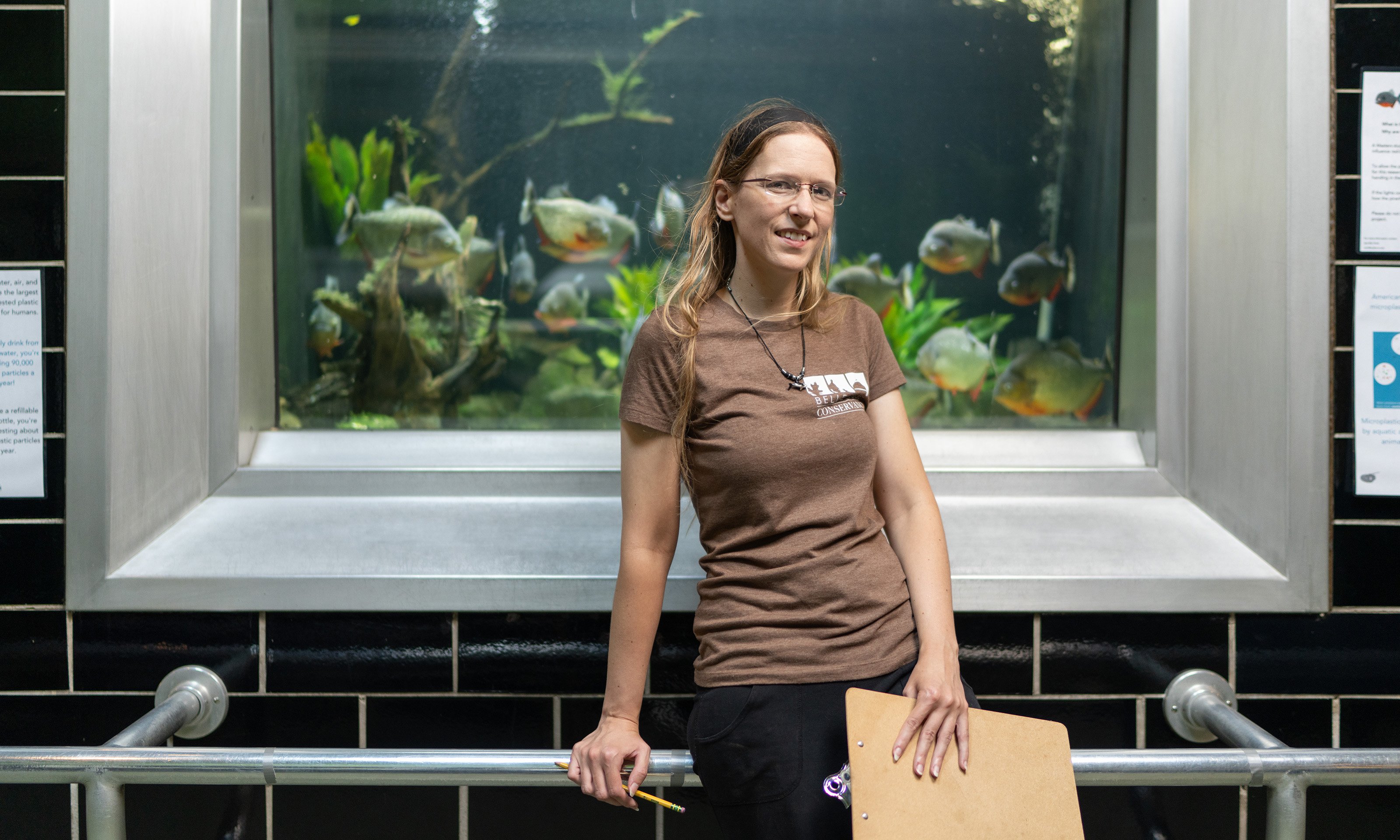 Woman standing in front of aquarium tank